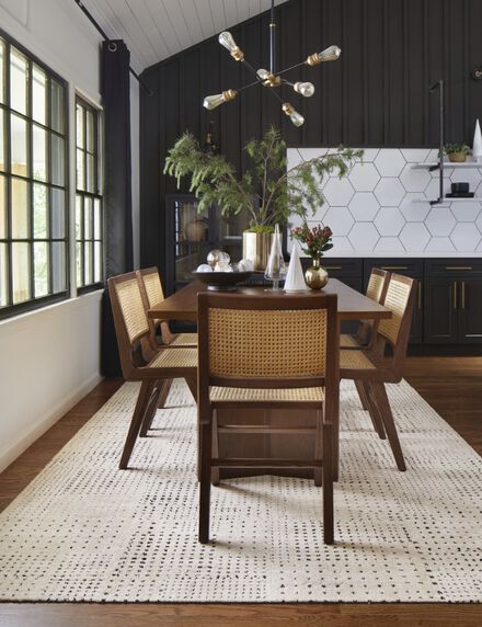 Dining room with wooden table and FLOR On The Dot area rug shown in Bone..